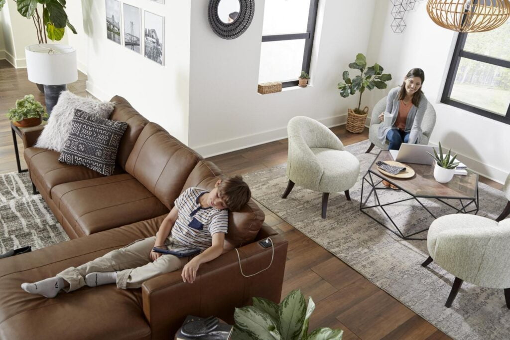 Living room set with mom and son by Best Home Furnishings